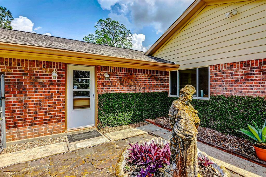 Beautiful side yard with fountain and landscaping.