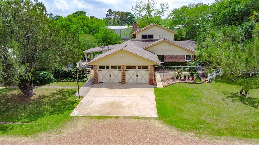 Well maintained two story home nestled in the trees and a fenced in private yard.