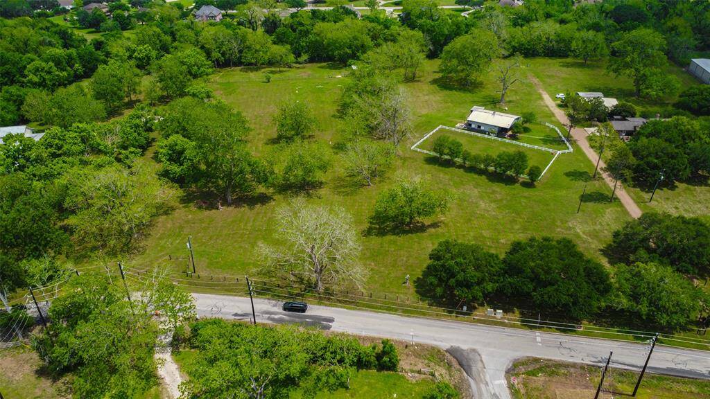 The property is bordered to the west by 700+ feet road frontage on Precinct Line and Jones Creek to the rear of the property as shown on this photo. Just minutes from the Grand Parkway and FM 359, it is located on land of the Old Three Hundred Jones Tract of the original settlers.