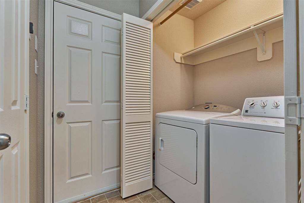 Utility room is located in back hallway near the garage entrance.
