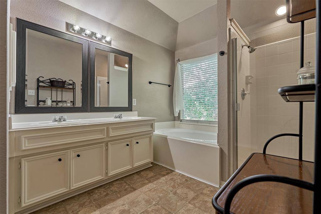 Dual sinks, garden tub and separate shower complete the primary bedroom suite.