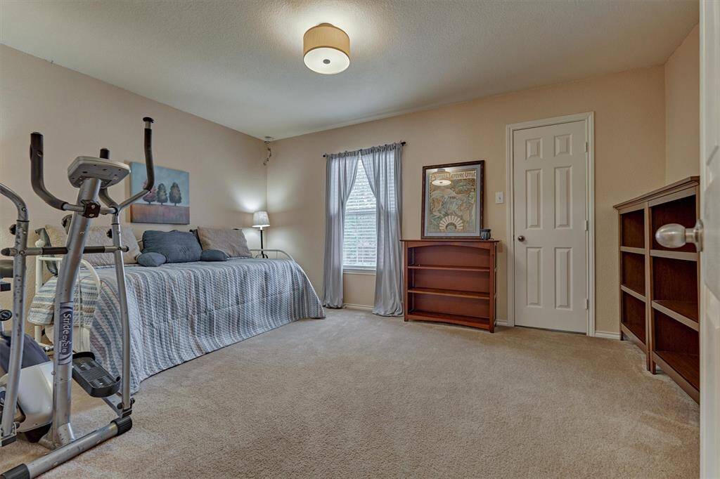 Large bedrooms provide room for creativity. This room allows for both sleeping space and exercise equipment.