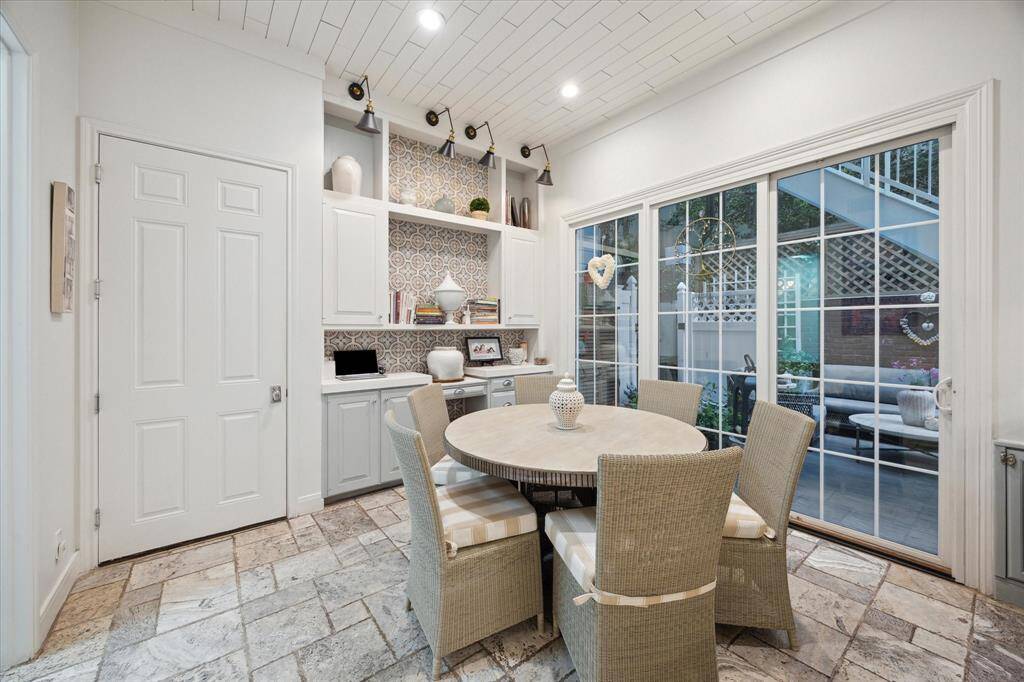 Large breakfast room with adjacent under counter seating and nice amount of storage on south wall.  Sliding Pella door leads to entertaining space and backyard.