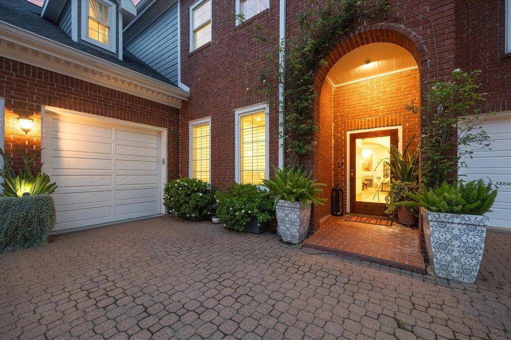 Gorgeous cobblestone courtyard with additional parking space in front of garage. The spot between Unit D and E is a shared space. This has worked well given kids going to and from college for extra parking. Planters that flank front door to remain. Iceberg Roses planted 2019. Garage divider and Gardenias planted 2023.