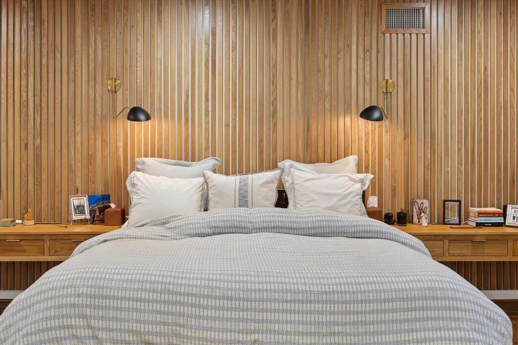 Custom wall of White Oak and reading lights added.  Again, the nightstands can be removed and we can take or leave the King Size frame if preferred.  There is a lot of additional space for a sitting area etc., on either side of the room.