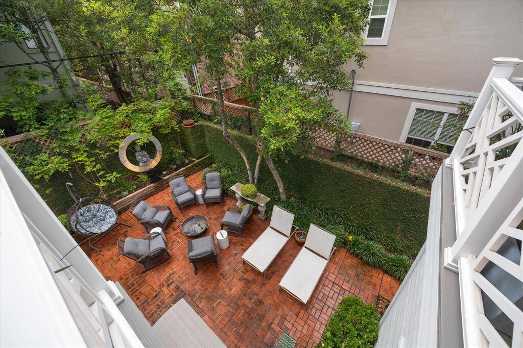 This is your view from the Primary Balcony as well as the Study at dusk.  Notice from an aerial view the amount of space for a pool.  The brick pavers can be taken up and used as accent for the pool  There are multiple French Drains around the perimeter for drainage.  Landscaping was just replaced from the freeze we had two years in a row.  There are Gardenia's, Peacock Iris, Wisteria, Camellia, Ivey and we've just added a trellised fence topper to give the  yard even more privacy.