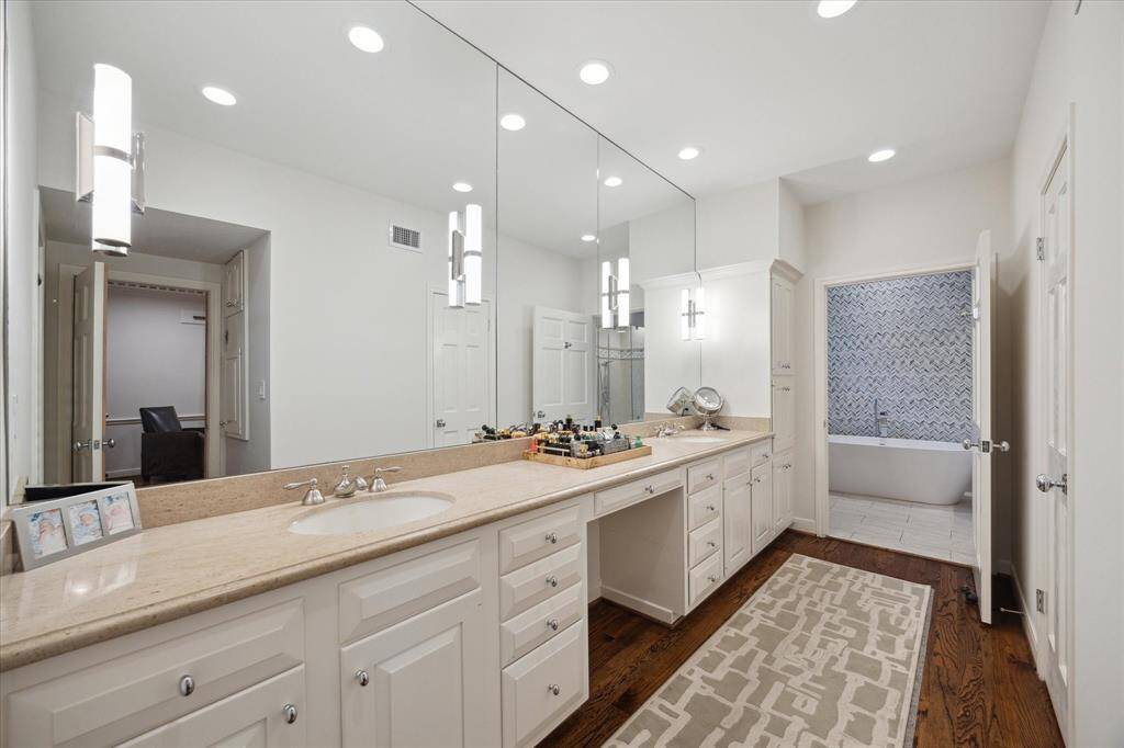 Primary Bath has an abundance of storage, linen closet and under counter seating with double sink and Travertine counter.  All mirrors, flooring, hardware etc., were installed within the last five years.