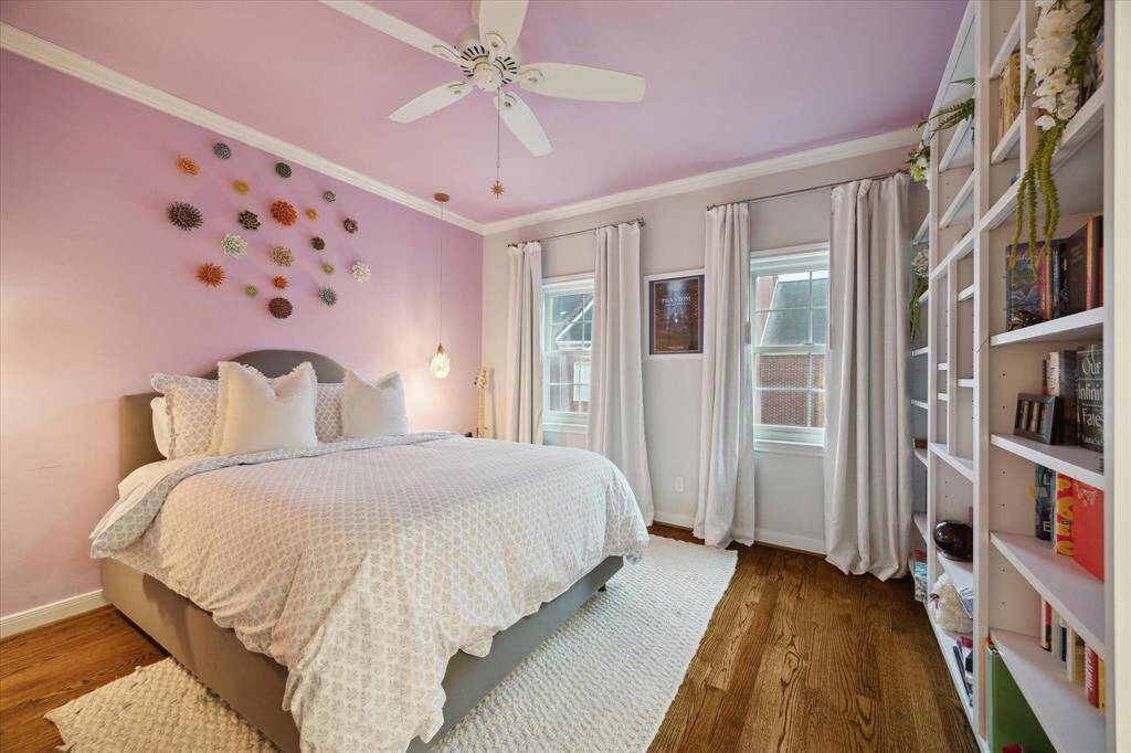 The third Bedroom on the second floor has a custom wall of bookshelves.  Great windows look over front courtyard.  Nice size walk-in closet and private bath with makeup area and great storage.