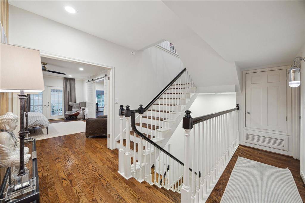 A view of the second floor landing coming out of the office and room above the garage with stairs leading to large Game Room and fourth bedroom and full bath.