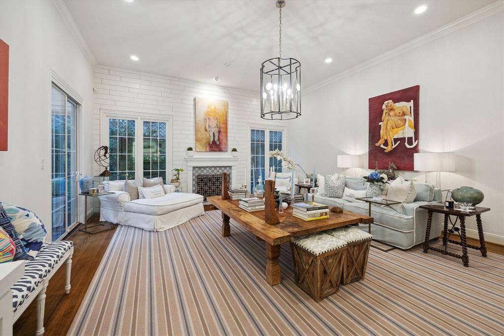 Formal living has gas /wood burning fireplace, Shiplap wall detail, beautiful multi-pane divided lite windows allow an abundance of natural light. High ceilings, with additional art lighting. All windows / doors are double insulated.