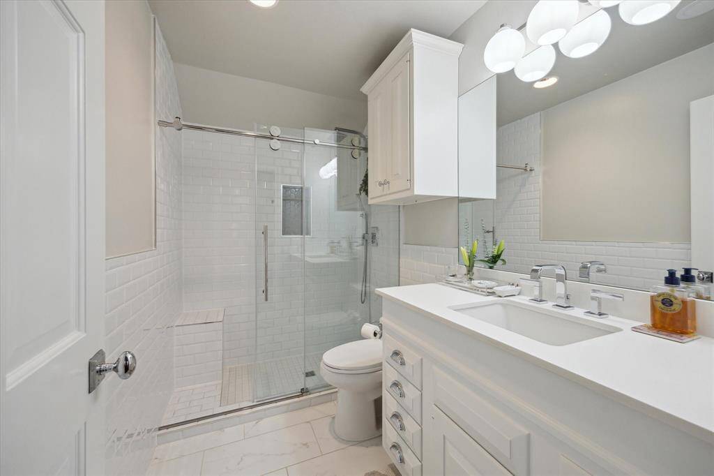 Fourth bedroom private full bath with great storage.  All showers come accompanied with hand wands for those times you don't want to mess up your hair or to expedite cleaning the shower area.