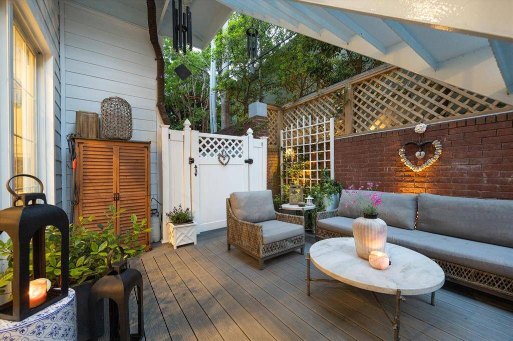 My favorite space to sit outside and relax.  Accent lighting, PVC fence, lattice fence topper, trellis' with ivy growing up them and gorgeous Silhouette Sweetgum trees and Gardenia's.  Treck decking was installed in this area and is easy to hose down.