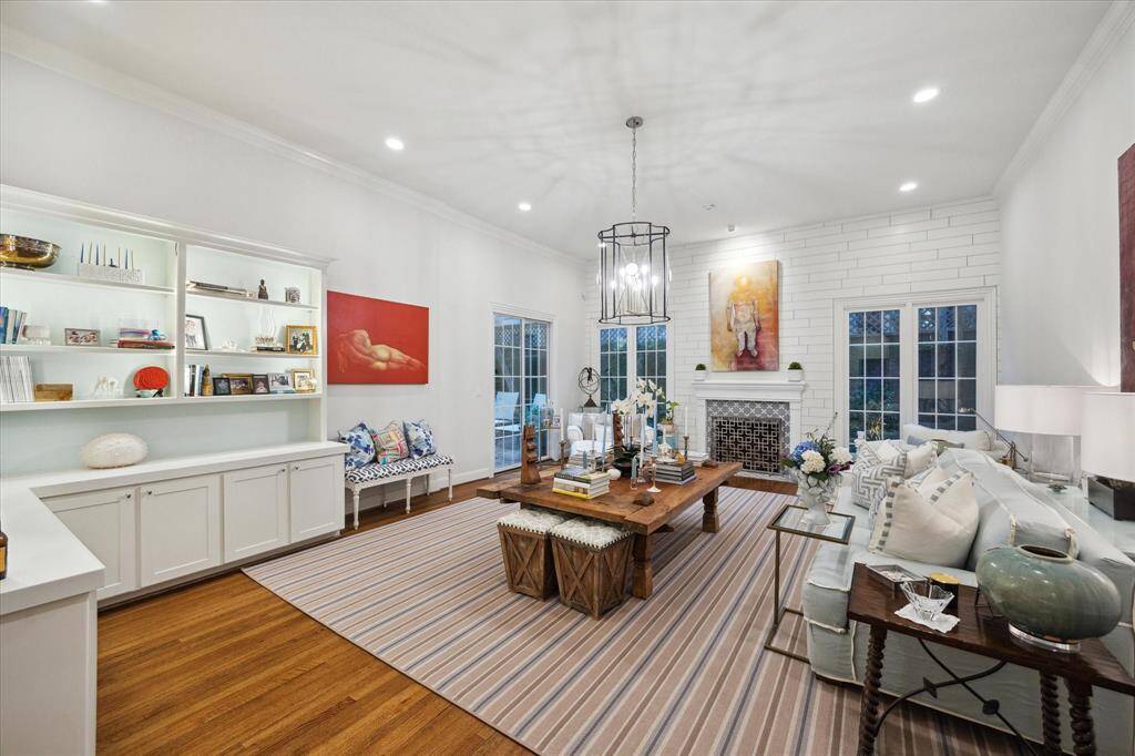 Formal living room has an abundance of built-ins as well as shelf side LED lighting. Great space with ease of access to backyard.