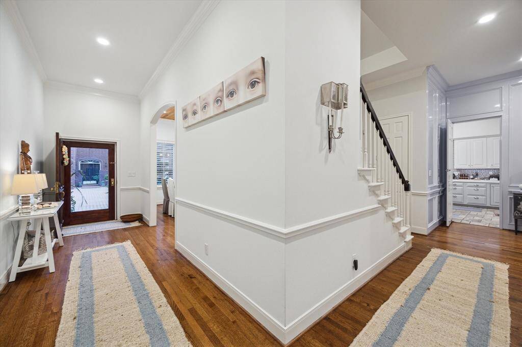 The Mahogany entry door of glass allows a lot of light to fill the entryway.  Nice proportionate space leads to entry and / or kitchen area and first floor study.