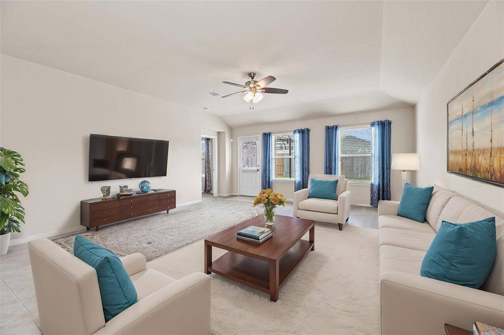The expansive living area is bathed in natural light, creating a warm and welcoming atmosphere—perfect for relaxing, entertaining, and making lasting memories with family