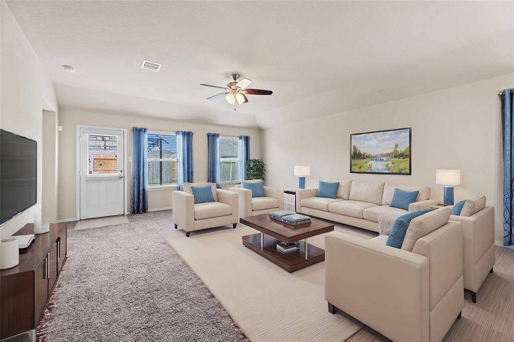 The wall of windows not only brings in abundant sunlight but also offers expansive views of the surrounding landscape, connecting the indoors with the outdoors in a seamless way.