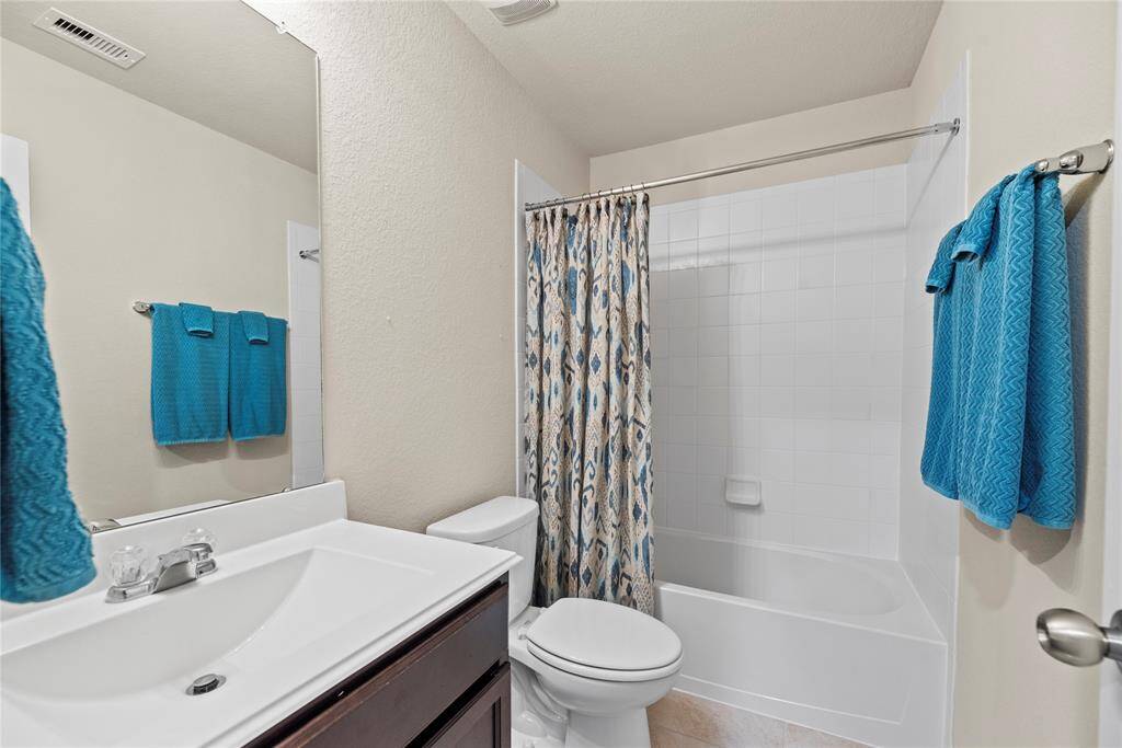 Your secondary bathroom with large vanity, offers convenience and comfort.