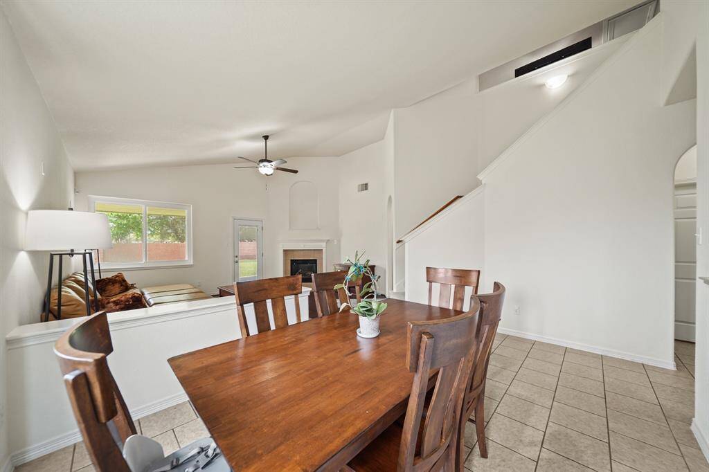 A view of the living room and staircase from the back of the dining room.