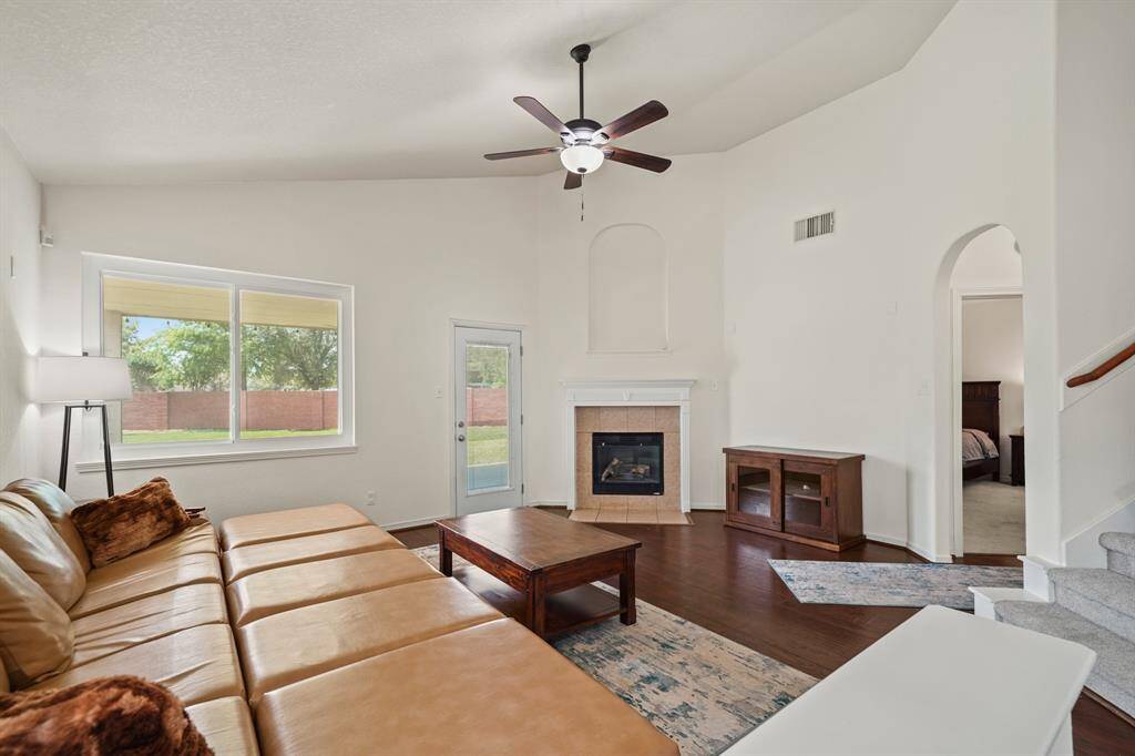 Large windows sits just next to a glass door with integrated mini blinds leading to the covered patio & backyard.