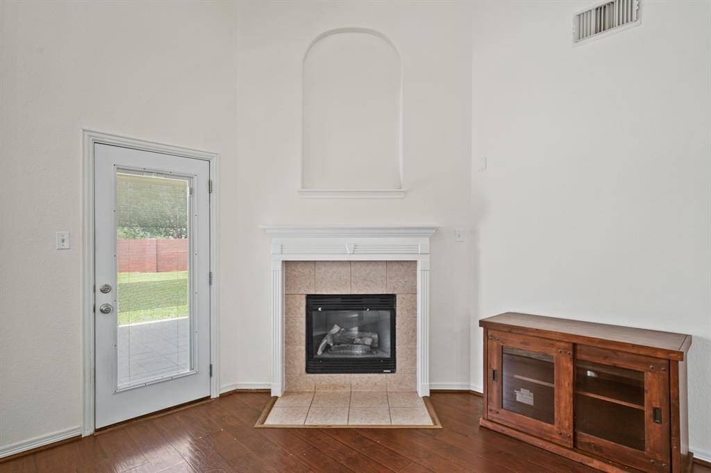 Cozy up to the tile surrounded gas log fireplace with mantel, recessed art niche and tiled hearth.