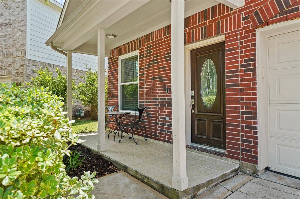 Welcome your family and friends to your new home on this charming covered front porch complete with recessed lighting, ceiling mounted security surveillance camera, a video door bell and tile flooring. A paved walkway leads to the double wide driveway and the home's two car attached garage.