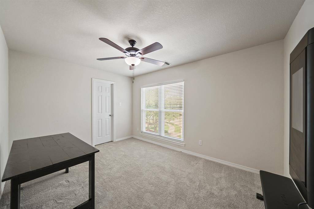 The third bedroom has a ceiling fan with lighting, window with blinds & carpet.