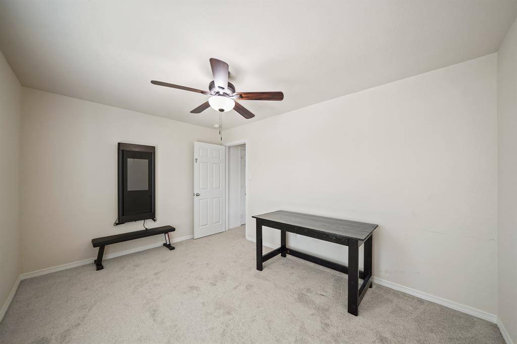 A view of the third bedroom with the corridor in the background.