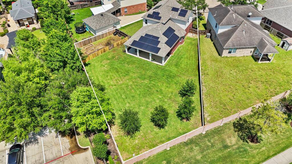 An aerial view of the home illustrating the oversized lot and fence lines.