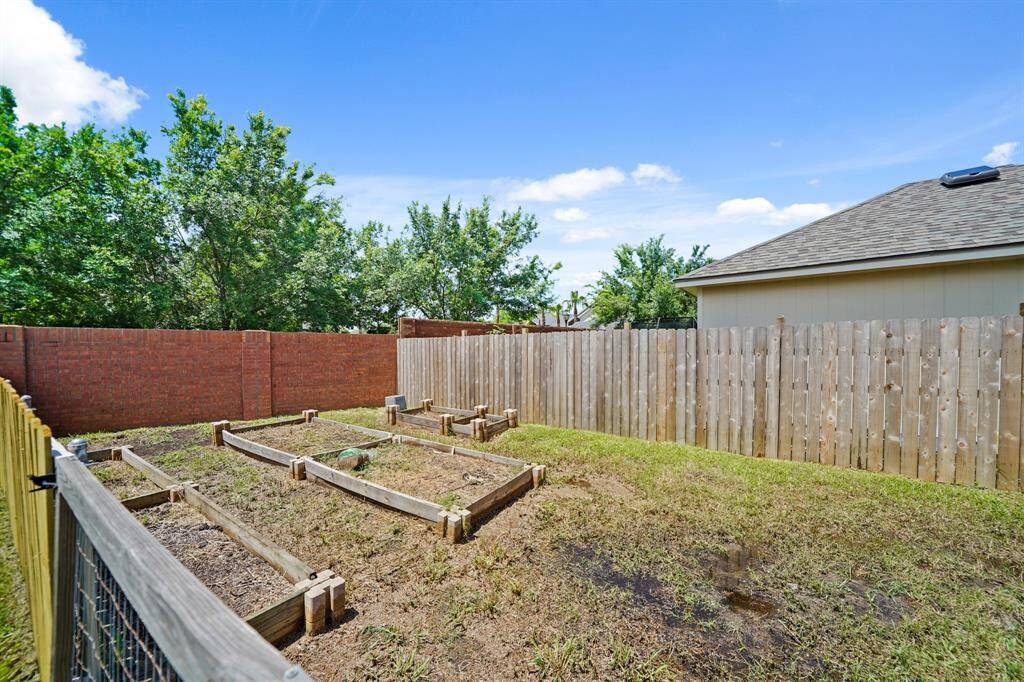 Ready for planting, raised beds are included in this spacious garden.