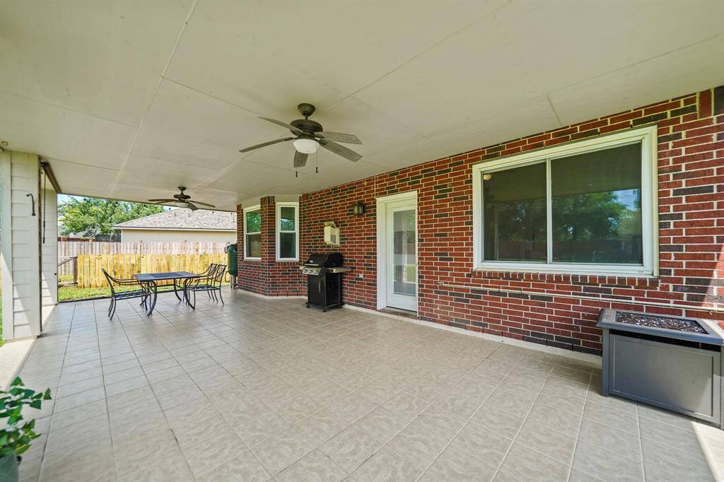 Surrounded by Edison string lighting, the 15' x 33' covered patio is perfect for outdoor dining & entertaining!