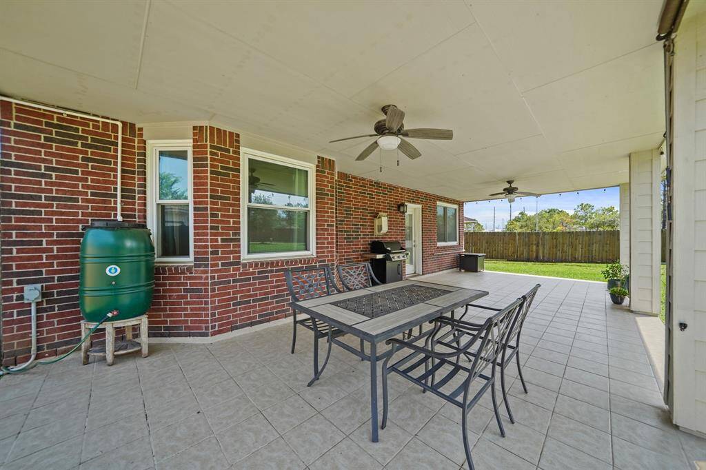 Supported by decorative columns, features include two ceiling fan with lighting and tile flooring. Offering convenient access to & from the kitchen, there's plenty of space for outdoor furniture, a barbecue grill etc.