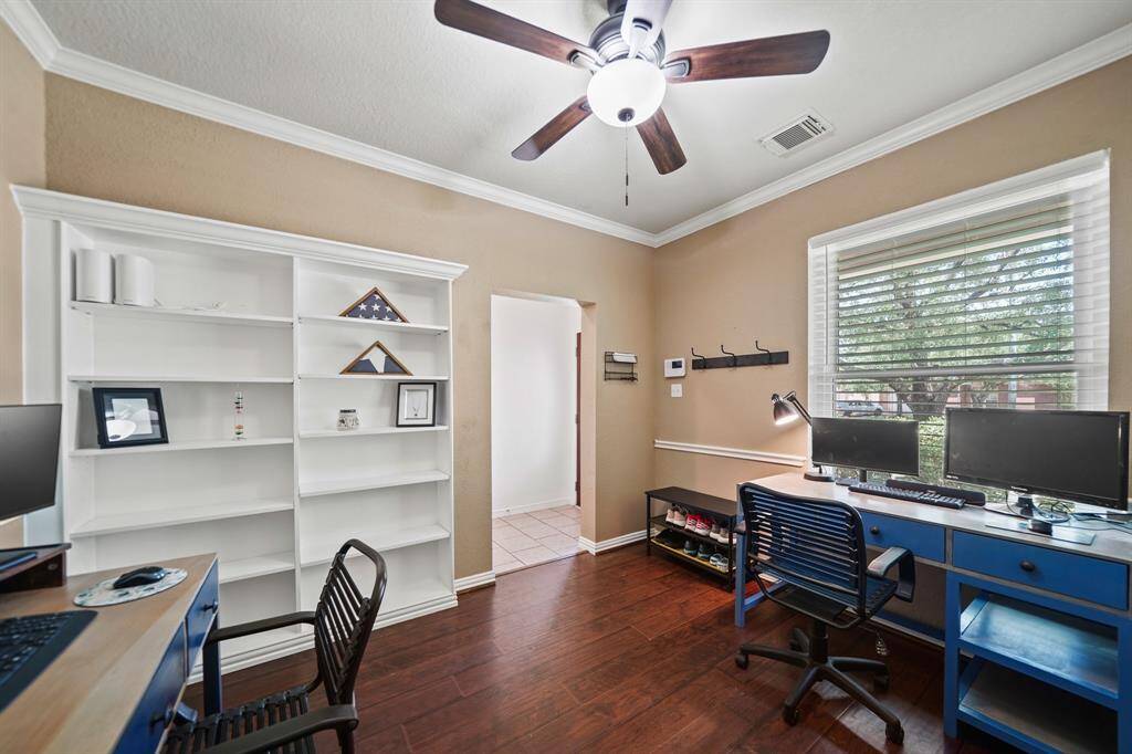 A large window with blinds overlooks the front yard and the built-in bookcases are perfect for displaying your family photos and most cherished mementos.