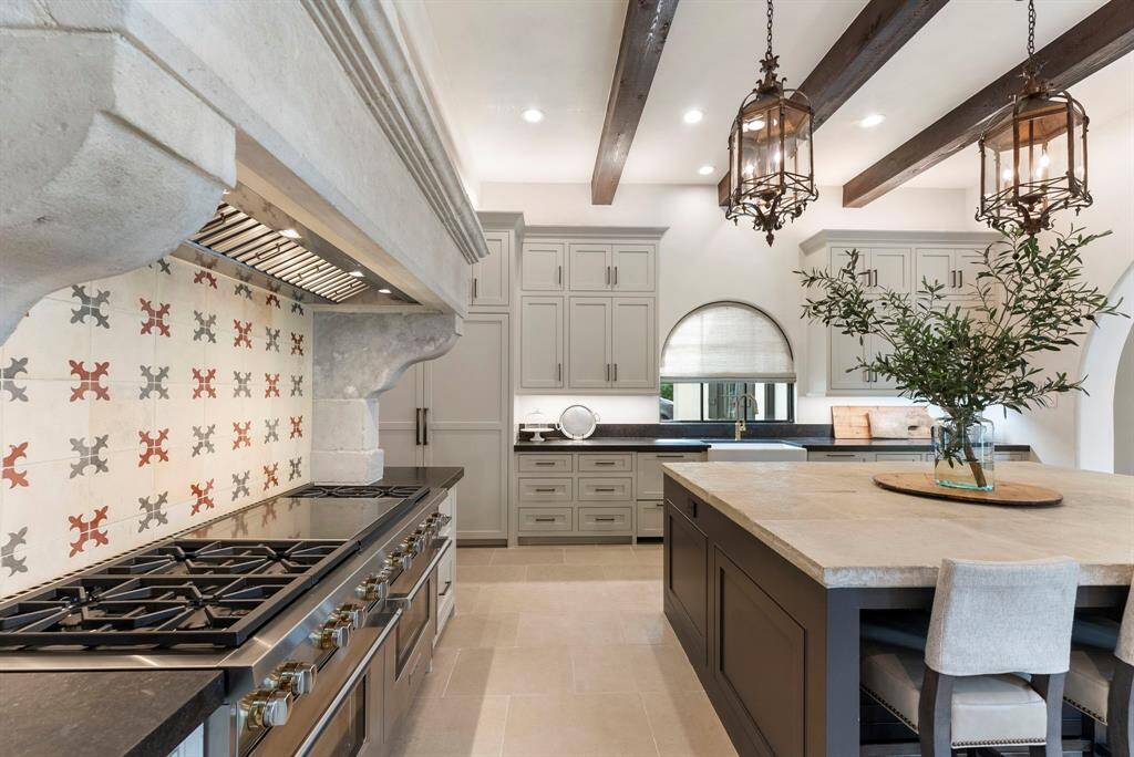 The kitchen is outfitted with premium appliances, including a high-end Wolf range and a built-in refrigerator.