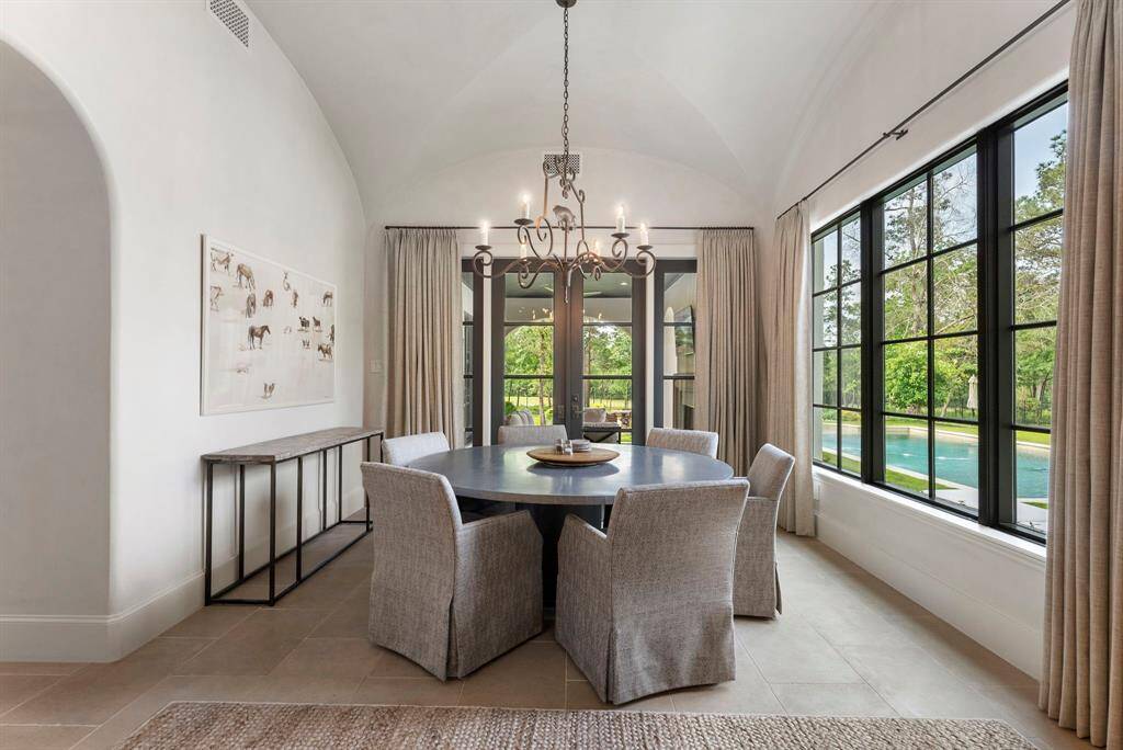Bright and inviting, the breakfast nook provides direct access to the outdoor kitchen and boasts breathtaking, unobstructed views of the backyard.