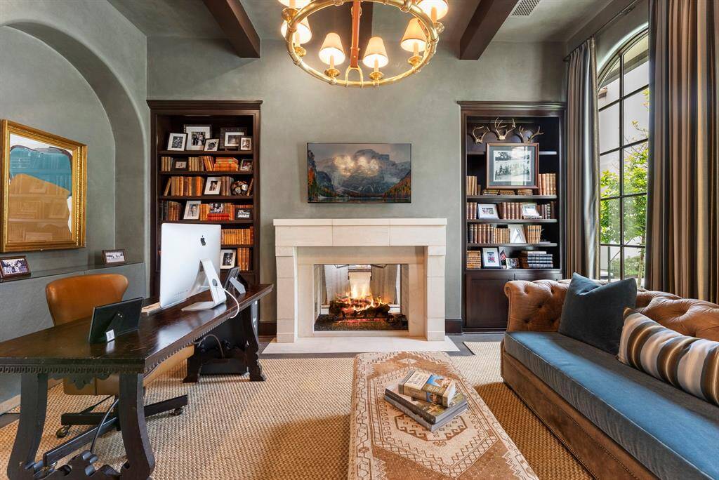 A refined study, complete with a two-way fireplace and elegant built-ins, offers the perfect blend of warmth and sophistication.