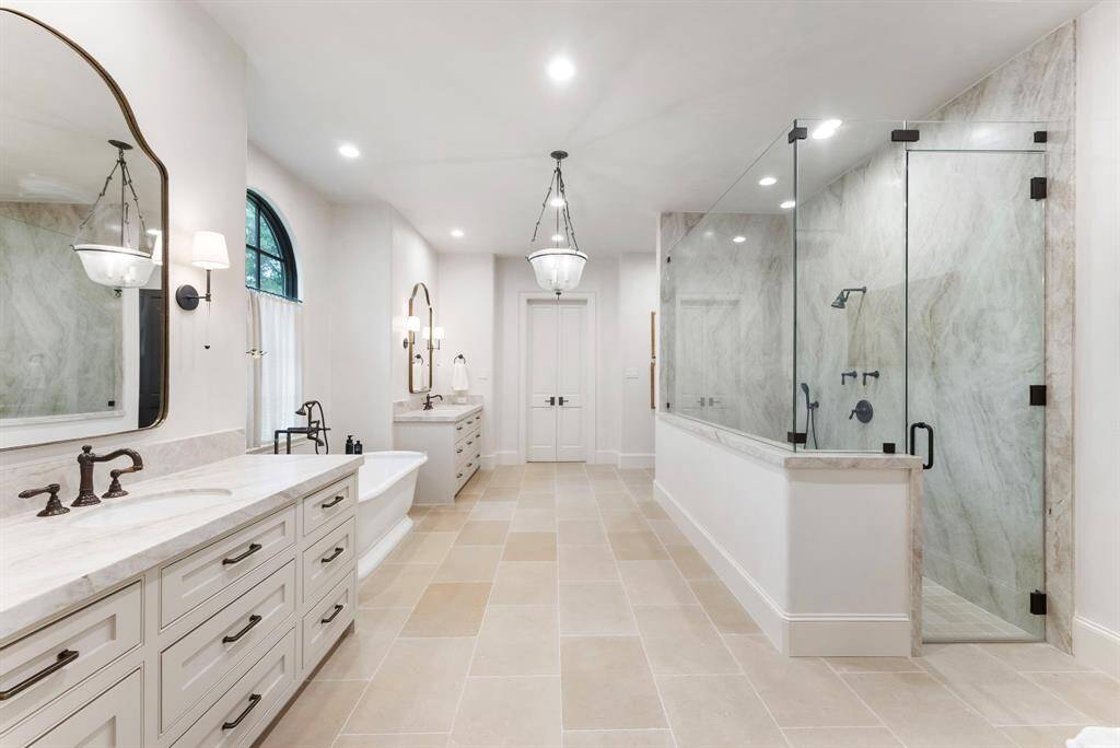 With its generous layout and high-end finishes, the bathroom exudes a true spa-like ambiance.