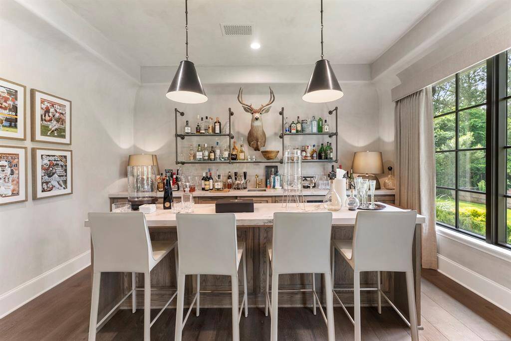 The custom bar is perfectly tailored for entertaining, offering a stylish and functional space to serve guests with ease.