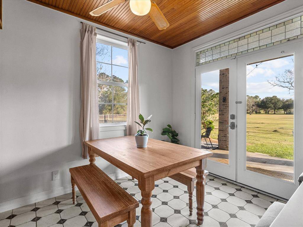 French doors lead seamlessly to the back covered patio, creating an easy flow between indoor and outdoor living, perfect for entertaining!