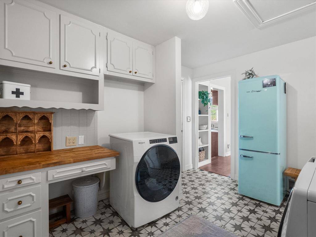 Convenient in-home laundry room featuring beautiful flooring, adding both style and functionality to your daily routine