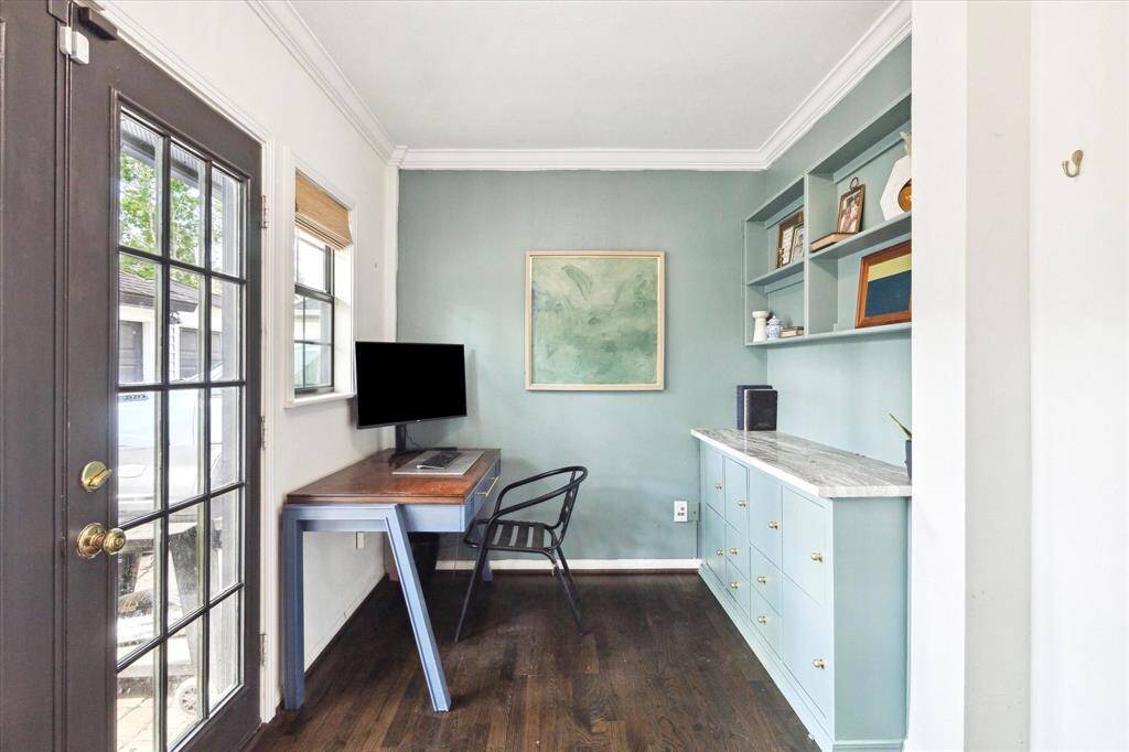 between the living room and backdoor is a pass through room with cabinetry/wine fridge on one side and a bonus space on the other.