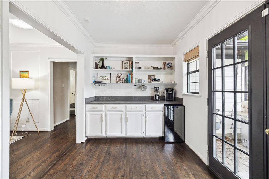 The bonus space directly across from white cabinetry. The cabinets here are faux, meaning you can keep with a built in look or remove it for larger space.