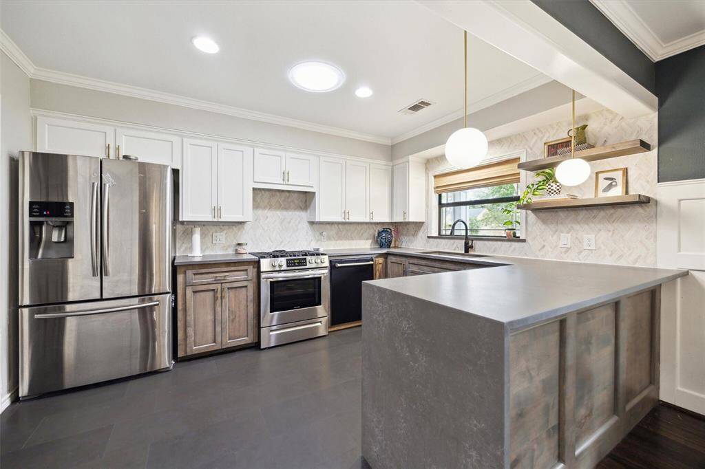 Kitchen features Hanstone quartz countertops and Volcano Basalt tile flooring