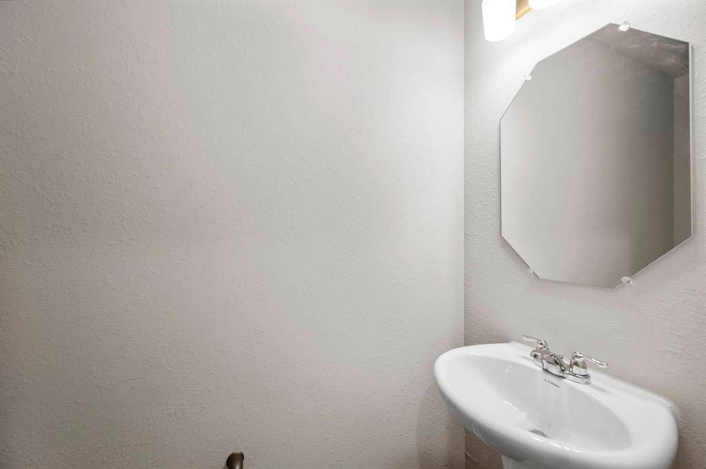 STAGED half bath for guests downstairs next to the utility room