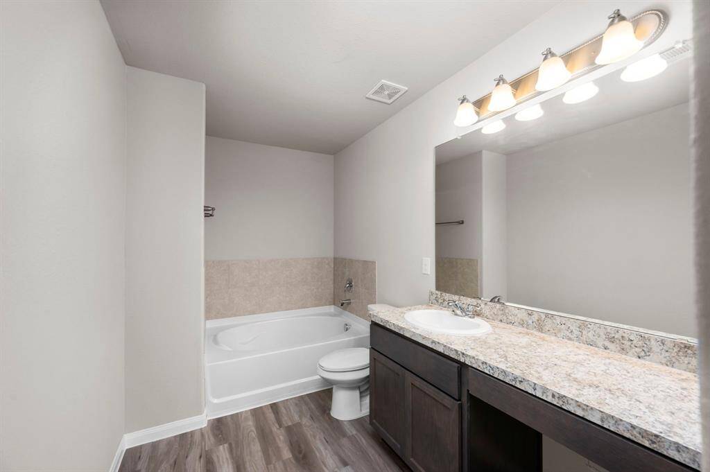 STAGED master bathroom upstairs attached to master bedroom with double sink vanity and tub.