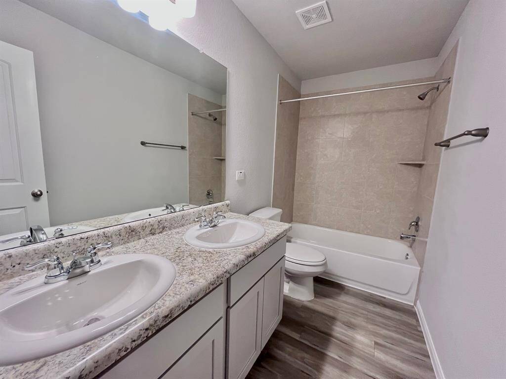 STAGED 2nd bathroom with double sink vanity and vinyl flooring