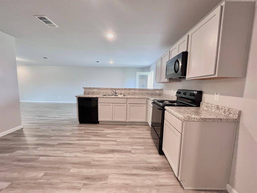 STAGED kitchen with vinyl flooring
