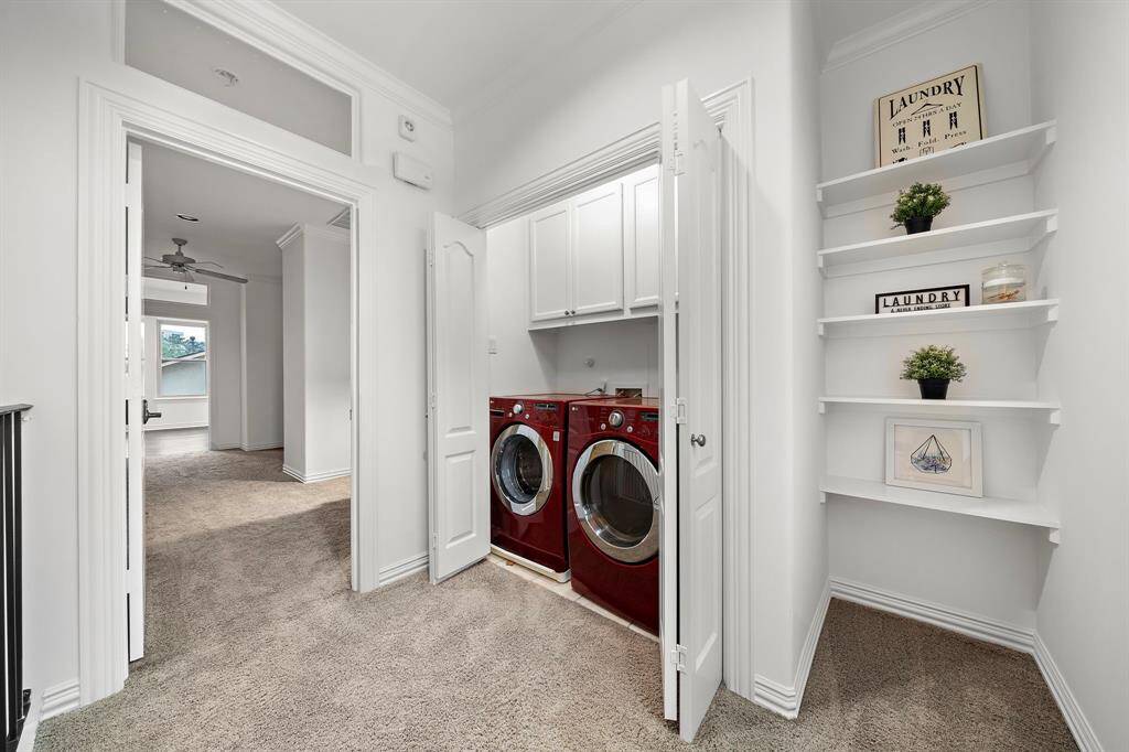 The laundry closet is conveniently located just outside of the primary bedroom.