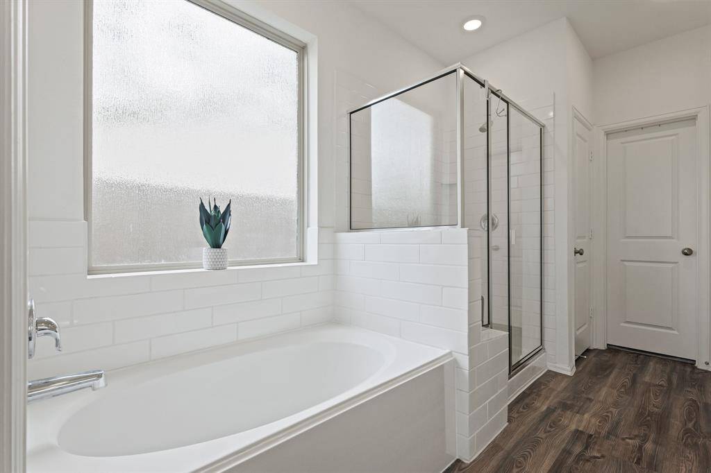Complete with a soaking tub, a standing shower, a vanity and a private water closet.