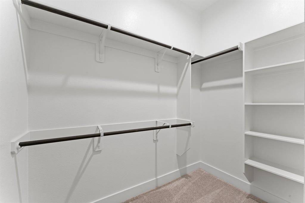 1 of 2 Walk-in Closets at Primary Bedroom