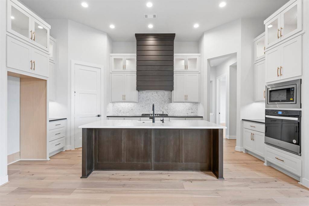 Kitchen with Stacked Cabinets, Hardware, and Under Cabinet Lighting
